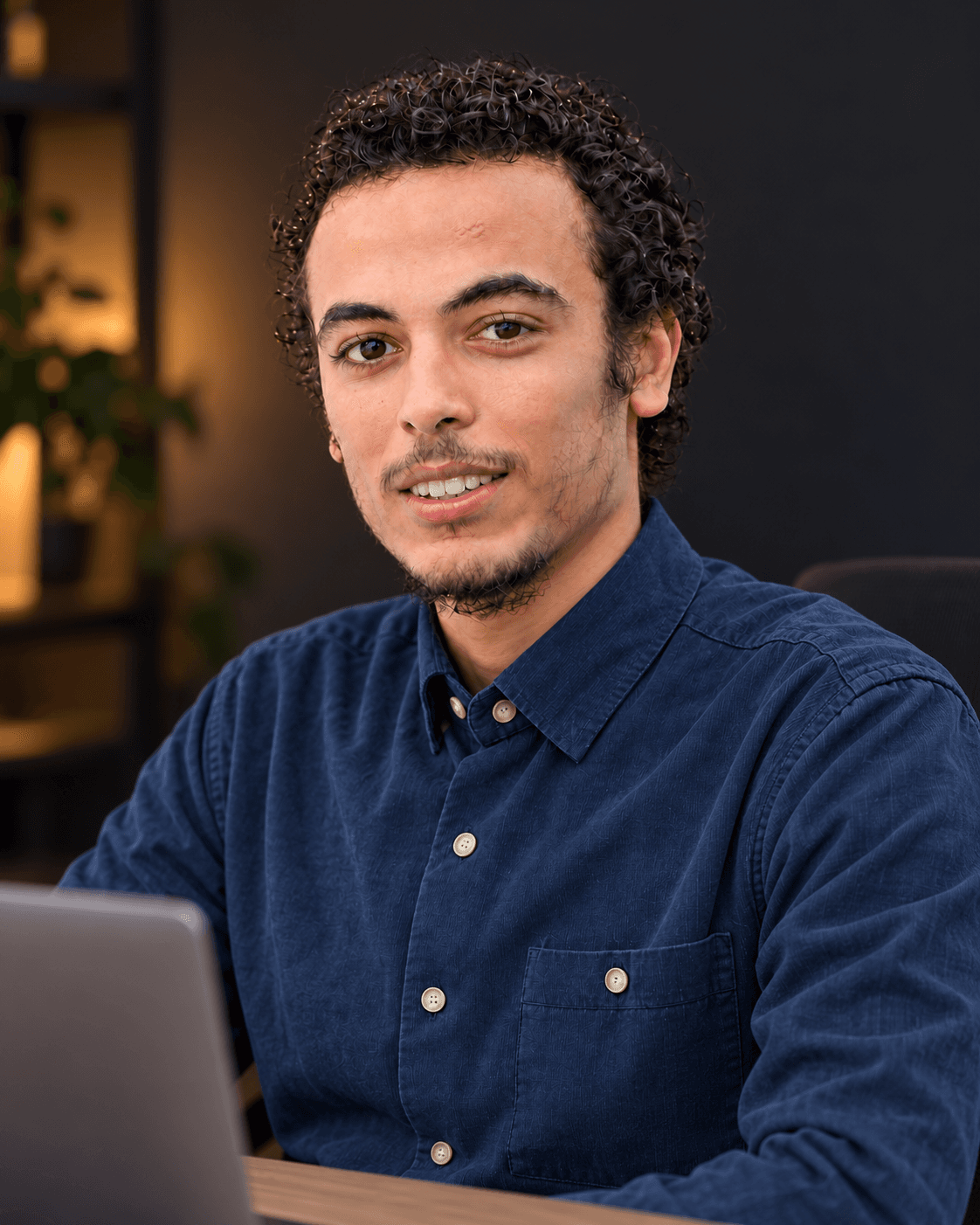 Ismail Raqi seated at a desk